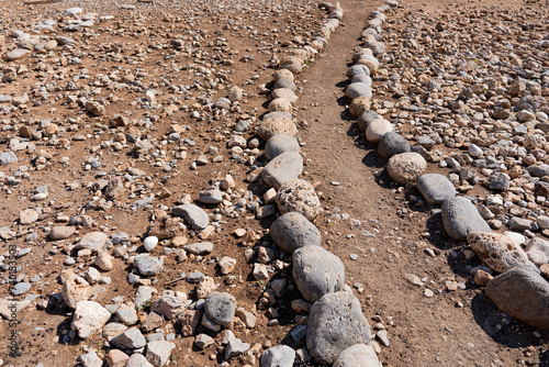 Beautiful and simple path made with pebbles and stones from the environment in the south of the Greek island of Crete next to the sea