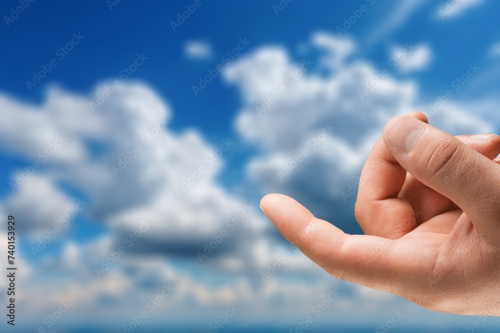 Human hand finger on nature sky background Human hand finger on nature sky background
