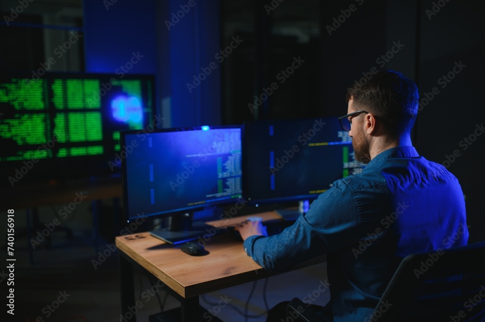 programmer working at desk in office programmer working at desk in office