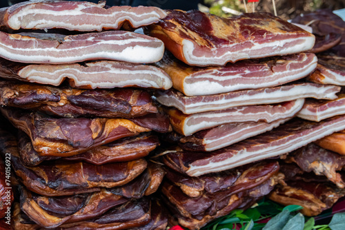 Exposed bacon and dried meat domestic products presented for sale on a farmer's market in Kacarevo village, gastro bacon and dry meat products festival called Slaninijada (bacon festival) held yearly  photo