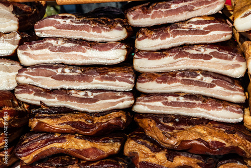 Exposed bacon and dried meat domestic products presented for sale on a farmer's market in Kacarevo village, gastro bacon and dry meat products festival called Slaninijada (bacon festival) held yearly  photo