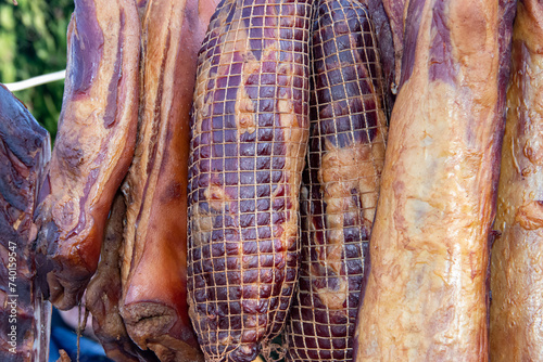 Delicious pieces of smoked meat exposed for sale in the market  presented for sale on a farmer's market in Kacarevo village, gastro bacon and dry meat products festival called Slaninijada (bacon fest)