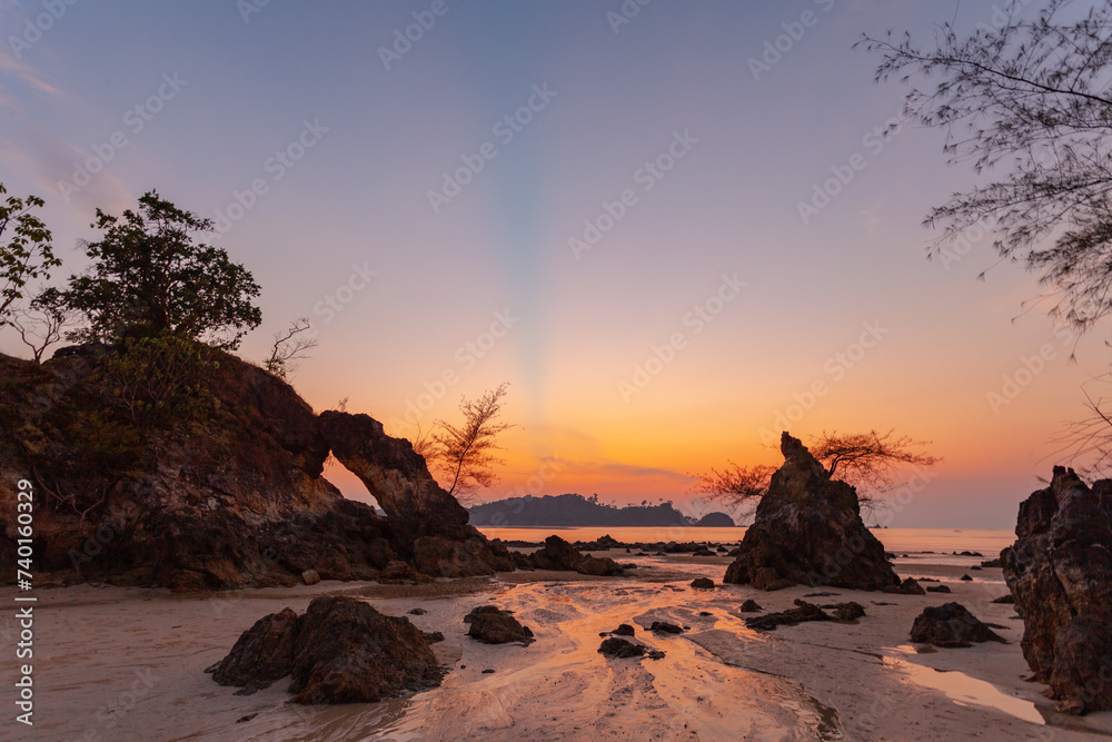 amazing The evening sun shone through the large rock hole and sparkled beautifully. .stunning sunset in the hole of unusual rock wave eroded into .the cavity like the arch with a hole. amazing The evening sun shone through the large rock hole and sparkled beautifully. .stunning sunset in the hole of unusual rock wave eroded into .the cavity like the arch with a hole.