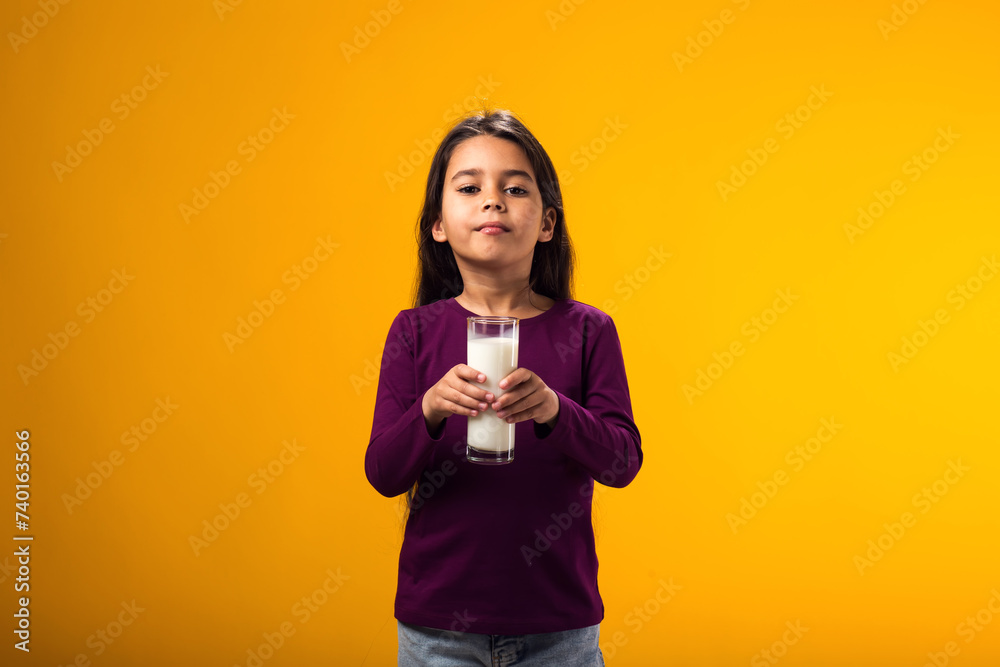 Child girl holding glass of milk. Nutrition and health concept Child girl holding glass of milk. Nutrition and health concept