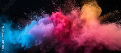 Colored splash explosion of multi-colored powder on a dark background. Holi celebration concept in India, background for holiday advertising and creative products or projects, banner with copyspace photo