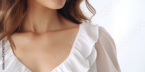 Close up of a woman wearing a white dress, suitable for fashion or beauty concepts