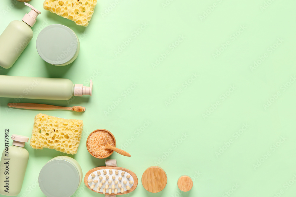 Composition with bath supplies and bowl with sea salt on green background Composition with bath supplies and bowl with sea salt on green background