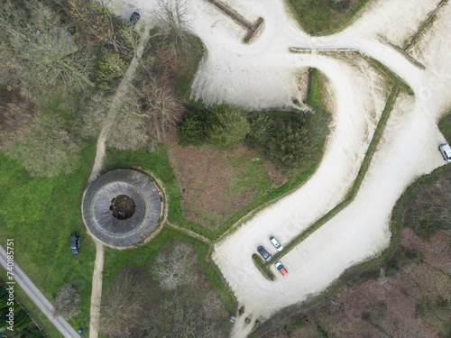 Aerial view of a nearly empty country car park seen in late winter. Dense woodland can be seen surrounding the car park, seen near Sherwood Forest in the UK. photo