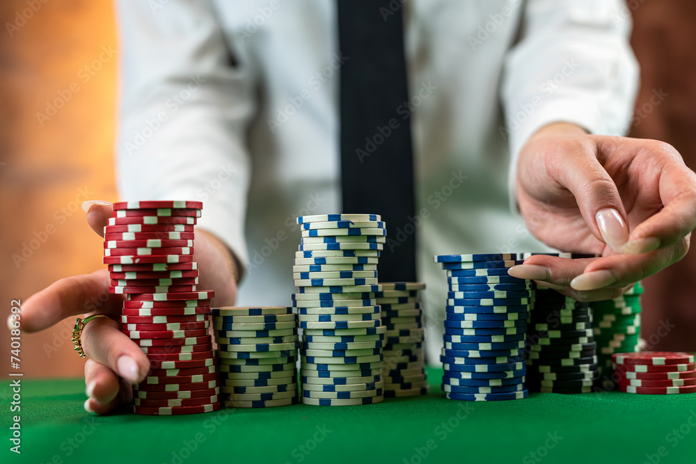 woman in a casino with many chips that she wraps up after a big win in poker. woman in a casino with many chips that she wraps up after a big win in poker.