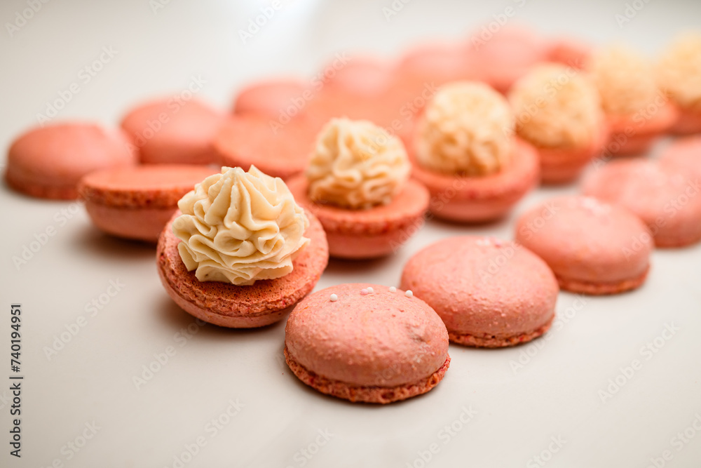 Beige macarons creation, infusing each with creamy