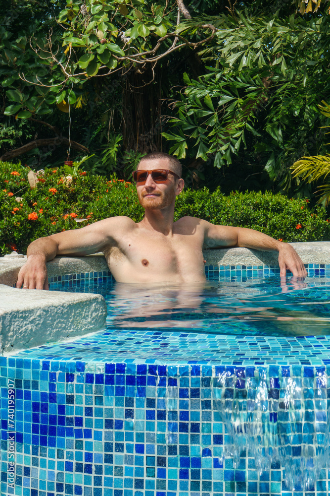 A man relaxing in the pool