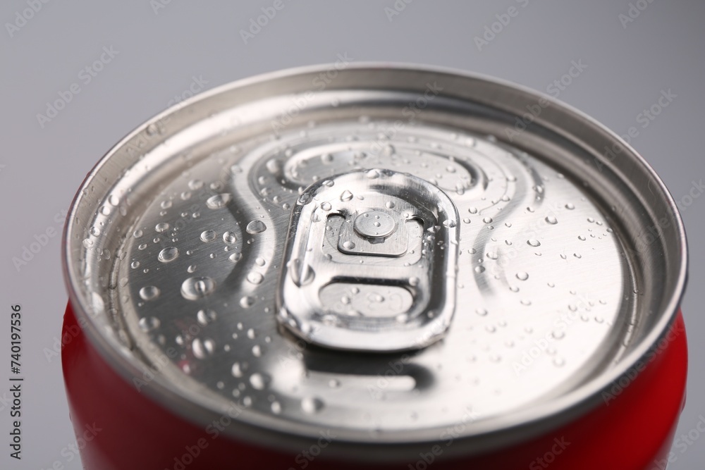 Energy drink in wet can on light grey background, closeup Energy drink in wet can on light grey background, closeup