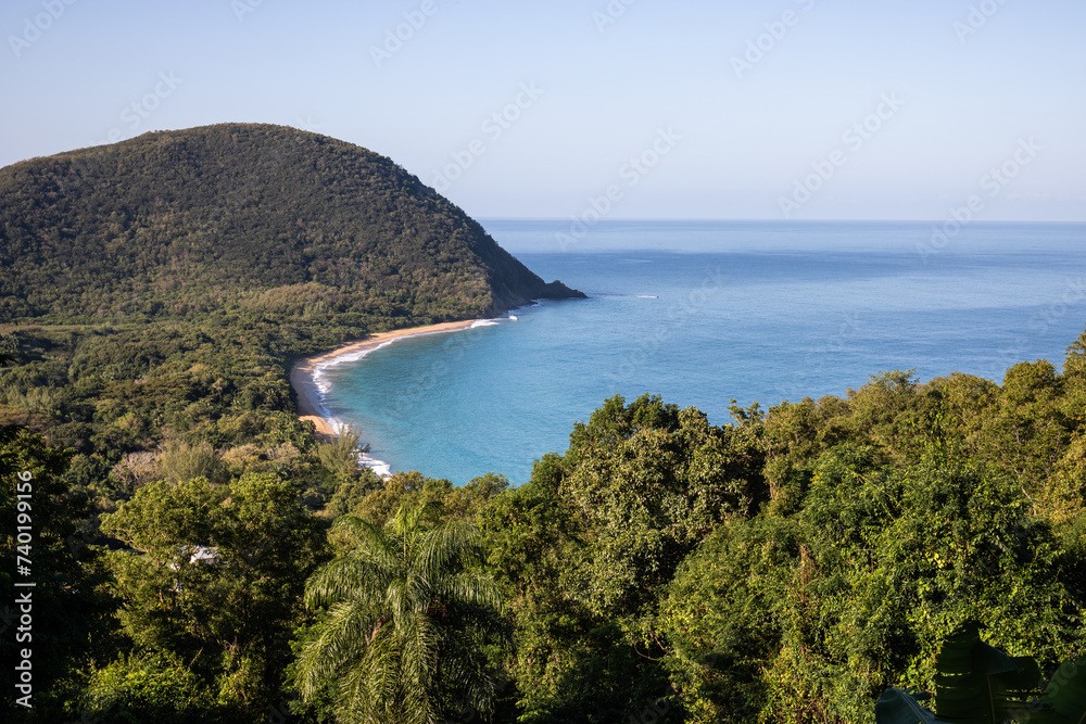 Guadeloupe, a Caribbean island in the French Antilles. View of the sandy beach of Guadeloupe. Caribbean vacation landscape. Grande Anse beach on the island of Basse-Terre. A secluded bay.