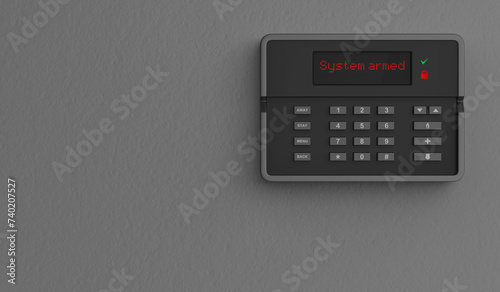 Home security alarm system on grey wall photo
