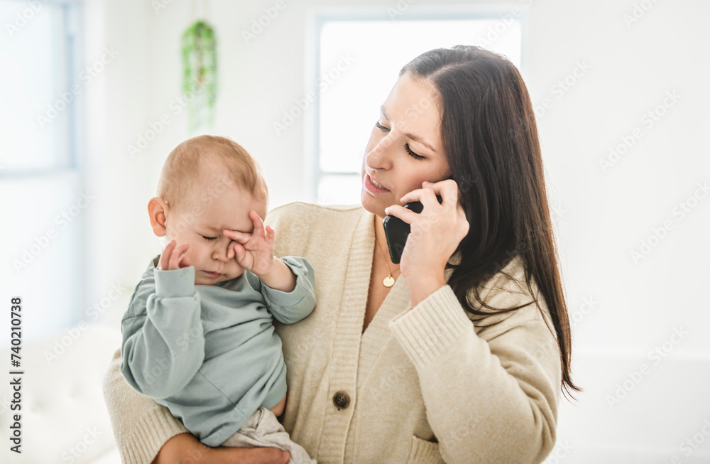 Mother calling to a doctor on phone worried about her baby desperately at home Mother calling to a doctor on phone worried about her baby desperately at home