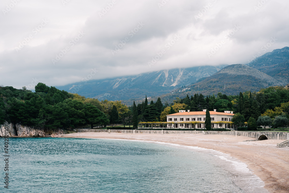 Clean deserted beach near Villa Milocer at the foot of the mountains. Montenegro