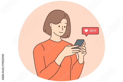 Smiling woman check likes on cellphone