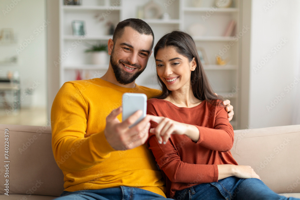 Shopping App. Happy Young Couple Using Smartphone At Home Together Shopping App. Happy Young Couple Using Smartphone At Home Together