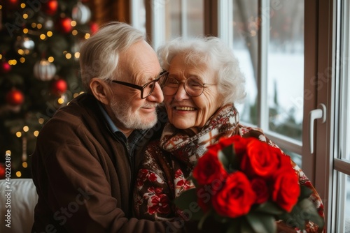 A senior couple shares a heartwarming embrace amidst the festive decorations of christmas eve, their smiles radiating love and joy as they hold onto each other and a bouquet of flowers