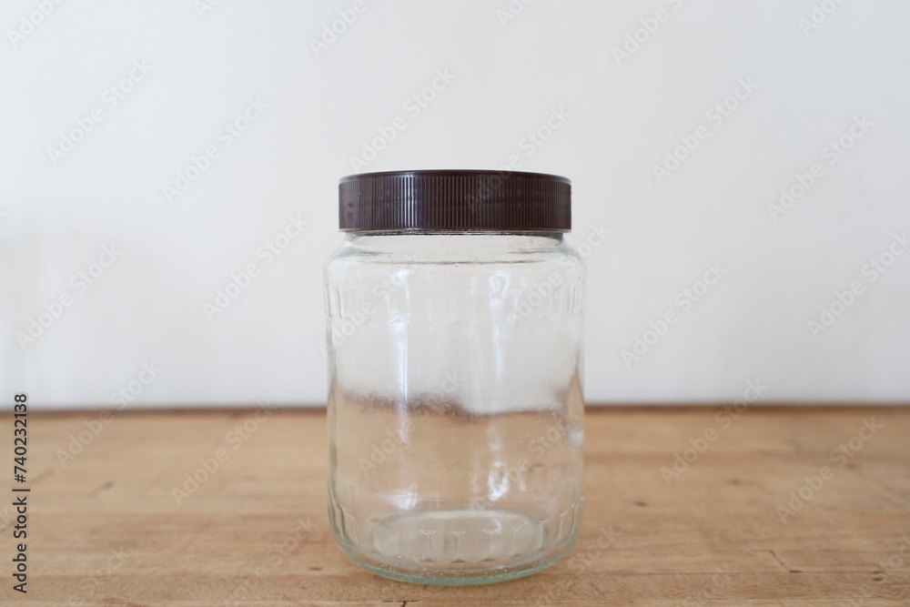 transparent empty glass jar on wooden counter transparent empty glass jar on wooden counter