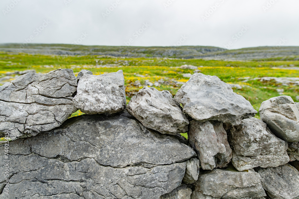 Irish dry-stone wall, built with a variety of stones to separate and protect crop fields as well as create separated fields for livestock grazing. Irish dry-stone wall, built with a variety of stones to separate and protect crop fields as well as create separated fields for livestock grazing.
