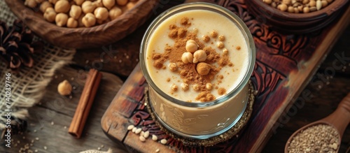 A glass of milk topped with a variety of nuts, including almonds, walnuts, and pistachios.