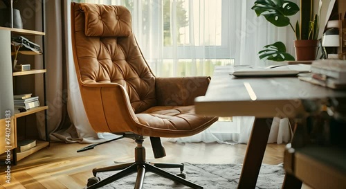Close-up of a stylish and comfortable office chair with adjustable features, placed in front of a minimalist desk in a cozy home office. photo