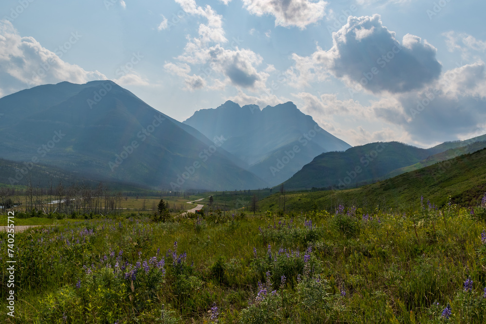 Obraz premium Sun rays shine through wildfire smoke haze, Waterton Lakes National Park, Alberta, Canada