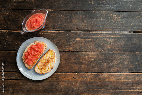 Freshly toasted bread with natural tomato and extra virgin olive oil in the morning before breakfast photo