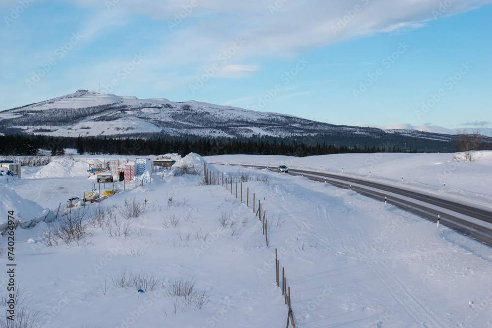 Snow covered road in arctic winter in Lapland, Sweden Snow covered road in arctic winter in Lapland, Sweden