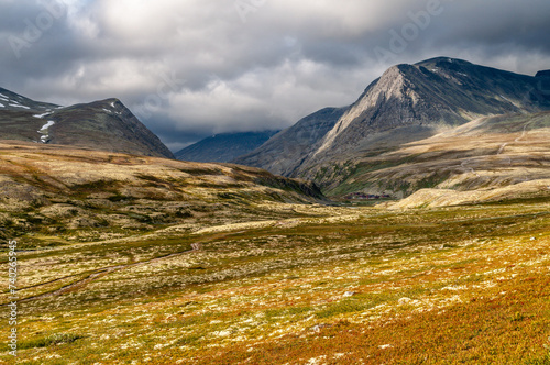 Rondane National Park - a hilly landscape with a meadow and high mountains in Norway in the north of Europe in Scandinavia