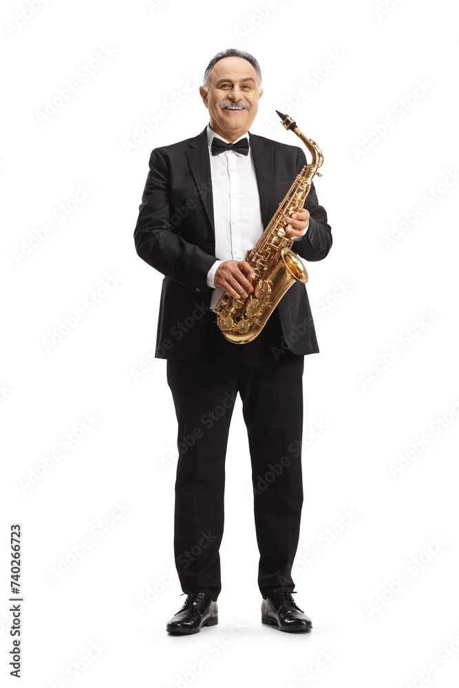 Fototapeta premium Full length portrait of a mature musician holding a sax and smiling