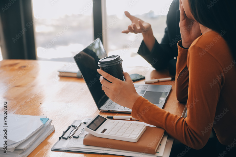 Fototapeta premium Successful business group are celebrating and looking to digital tablet together at the meeting. People are raising arms.