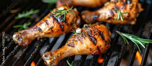 Juicy grilled chicken legs infused with flavorful herbs sizzling on a hot grill.