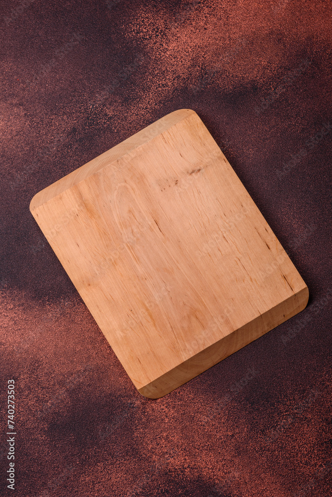 Fototapeta premium Empty rectangular wooden cutting board on textured concrete background