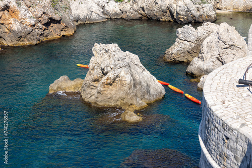 Transportation of colorful kayaks for tourists by water on the Adriatic Sea to the West Harbour, Dubrovnik, Croatia photo