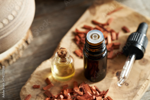 A brown bottle of essential oil with red sandalwood