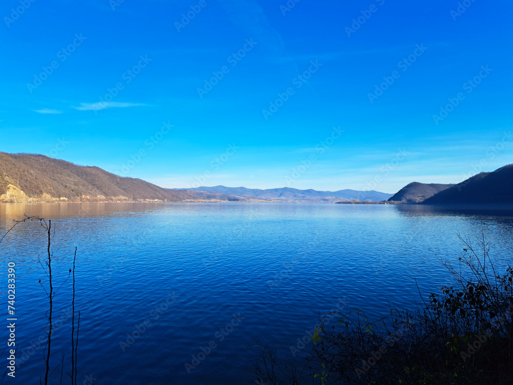 Obraz premium Horizontal photo of a lake formed on Danube river near Golubac town and fortress