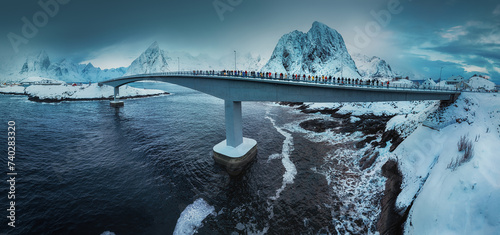 Lofoten Islands, Reine, Norway and bridge to Hamnoy fishing village with red rorbuer houses in winter nature panorama landscape