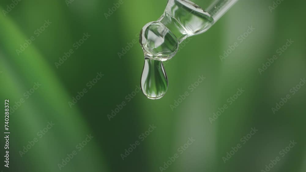 Serum drop falling from pipette with essential liquid. Cosmetic or medical liquid in slow motion. Dermatology science laboratory. Natural medicine research and organic skin or body care products