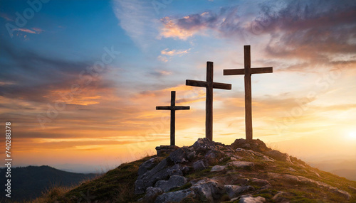 Three crosses on hill at sunset, symbolizing Crucifixion of Jesus Christ. Religious concept with space for caption