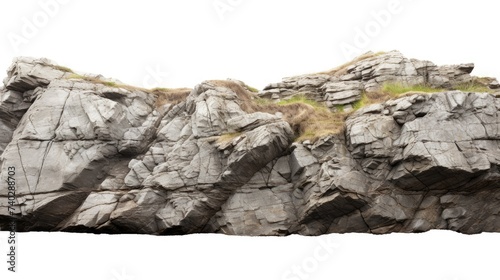 Majestic Rock Formation with Lush Green Grass Growing Atop Against White Background