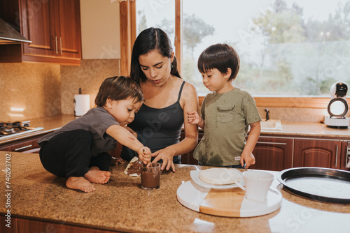Mother cooking with her boys