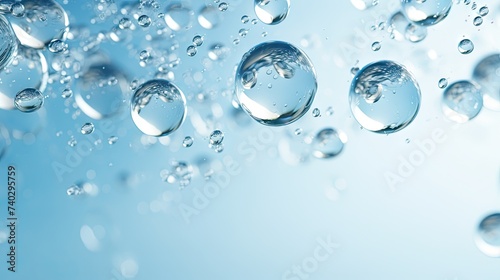Glistening water droplets on a serene blue background with bubbles rising