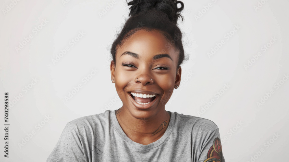 A cheerful woman with red hair tied in a bun, laughing joyfully in a casual grey t-shirt, her freckles and bright expression conveying happiness. A cheerful woman with red hair tied in a bun, laughing joyfully in a casual grey t-shirt, her freckles and bright expression conveying happiness.