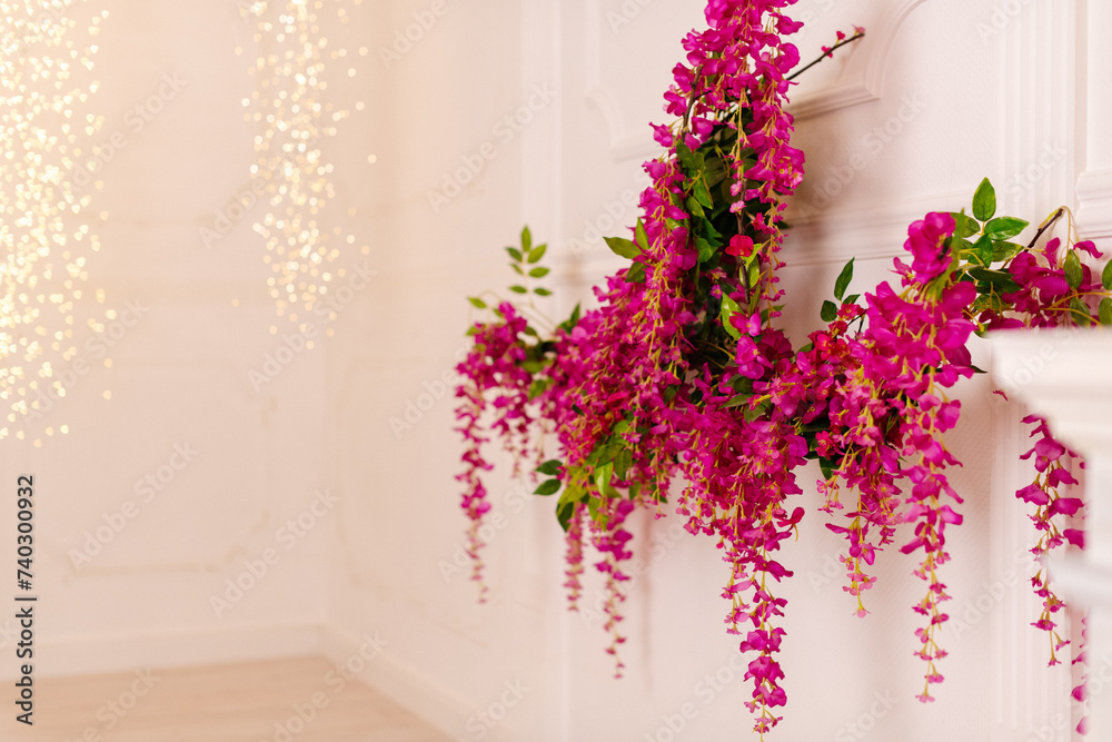 Fototapeta premium Hanging pink artificial flowers creating a lush and vibrant display, perfect for events or interiors.