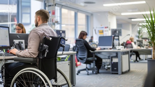 A man in a wheelchair navigates the bustling office, his sharp suit contrasting with the sleek furniture as he types away at his computer while a woman stands by his side, the walls of the modern off