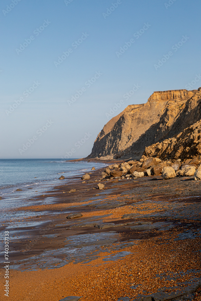The cliffs and beach at Whale Chine on the Isle of Wight, with a blue sky overhead