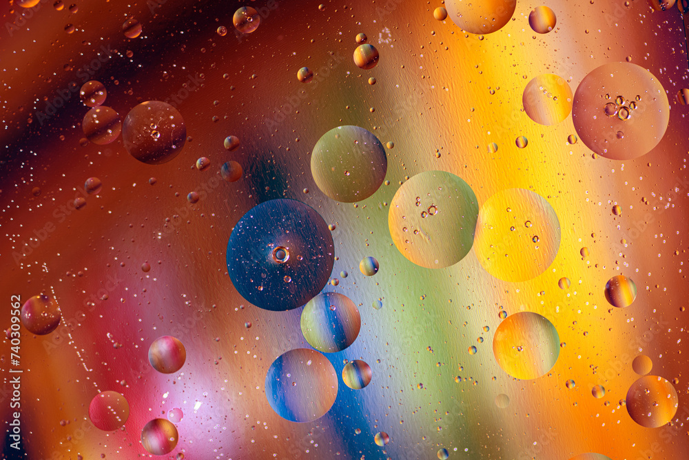 Fototapeta premium Colorful artistic of oil drop floating on the water. Abstract colors water bubbles background. holiday light background. oil drops on the water surface