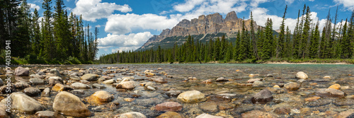 Summer time stunning views at Castle Mountain in Banff National Park with views along the turquoise Bow River in Alberta. Beautiful blue sky day with clouds. 